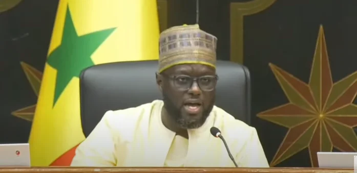 El Malick Ndiaye addressing the media during a parliamentary session