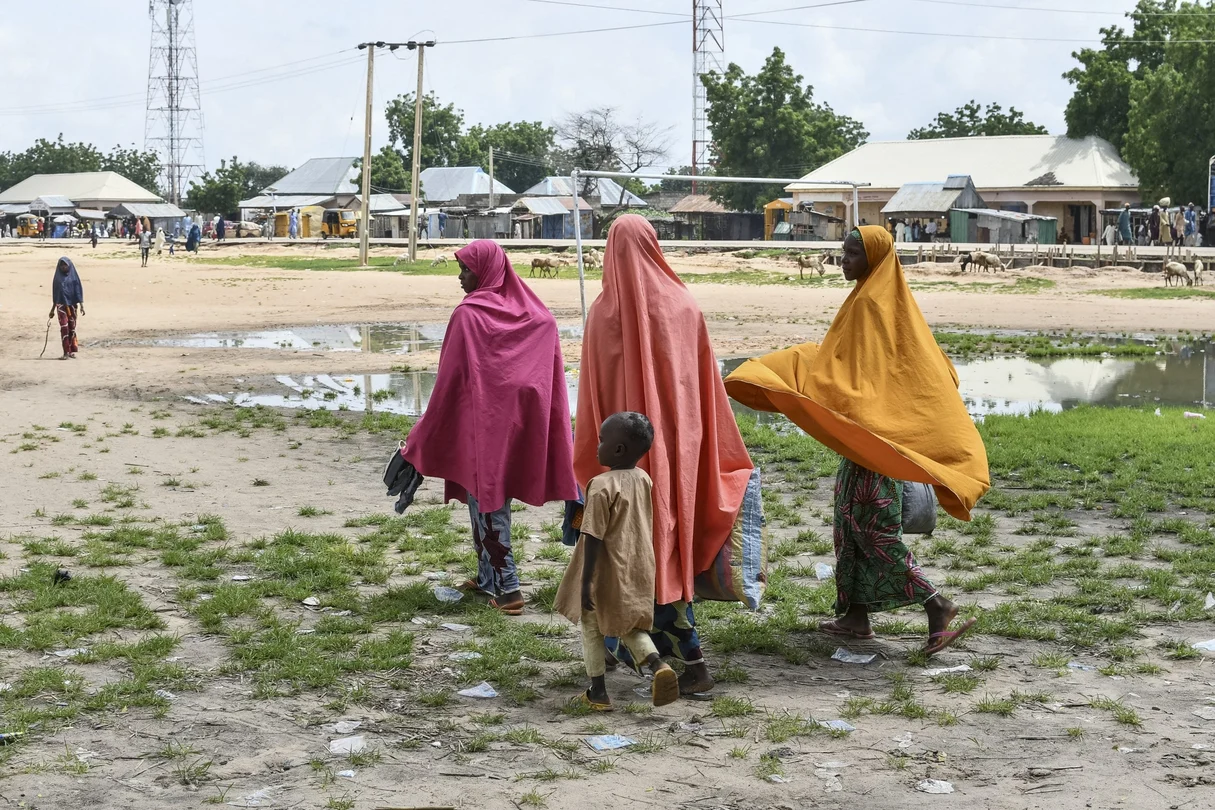 Survivors and relatives of victims of a suspected Boko Haram attack walk in Babban Gide on September 4, 2024. At least 81 people were killed and several reported missing after an assault by suspected Boko Haram jihadists in Yobe State, northeastern Nigeria, local officials confirmed.