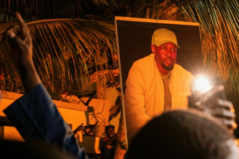 Supporters of Ousmane Sonko holding his portrait