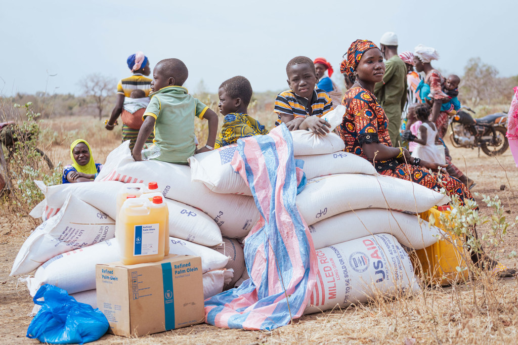 Vulnerable populations in Morolaba, Burkina Faso, receive emergency food aid via airlift.