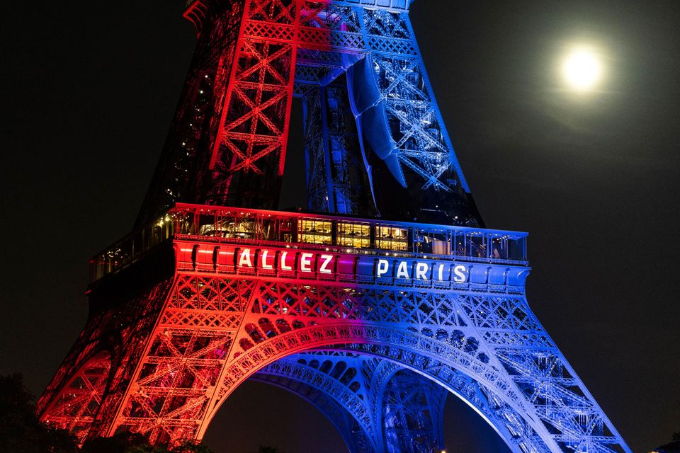 Eiffel tower lit up in Paris saint-germain and arsenal colors