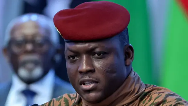 Close-up of Ibrahim Traoré in military attire, wearing a red beret.